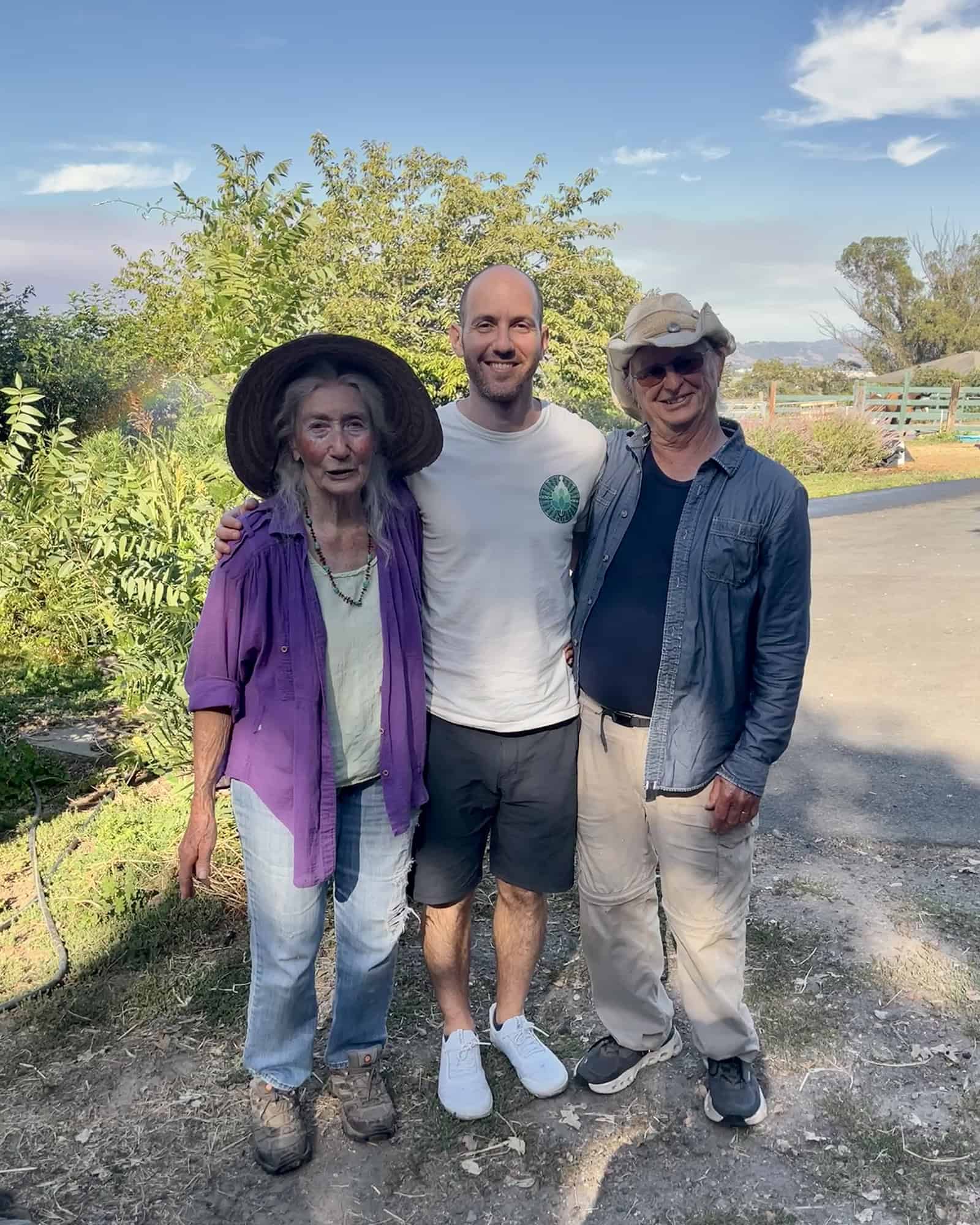 Yoni standing in nature with Dr. Aubrey Degnan and her husband, symbolizing shared devotion to healing.