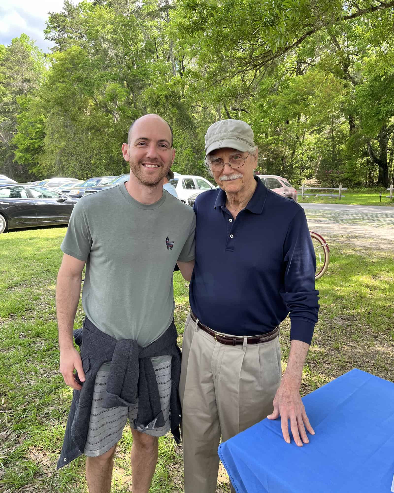 Yoni standing outdoors with spiritual teacher Michael Singer, representing wisdom and mentorship.