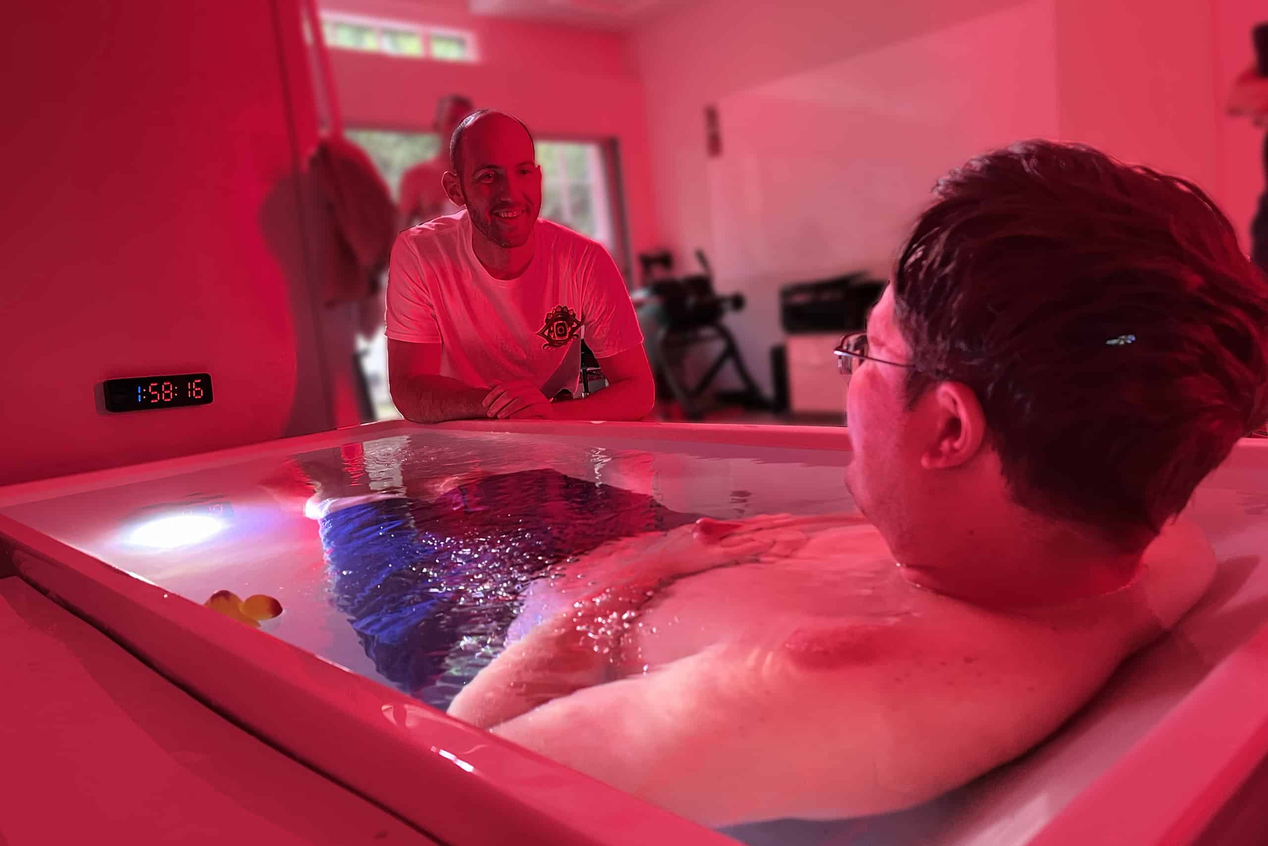 Yoni guiding a man through a cold plunge experience, fostering courage and trust.