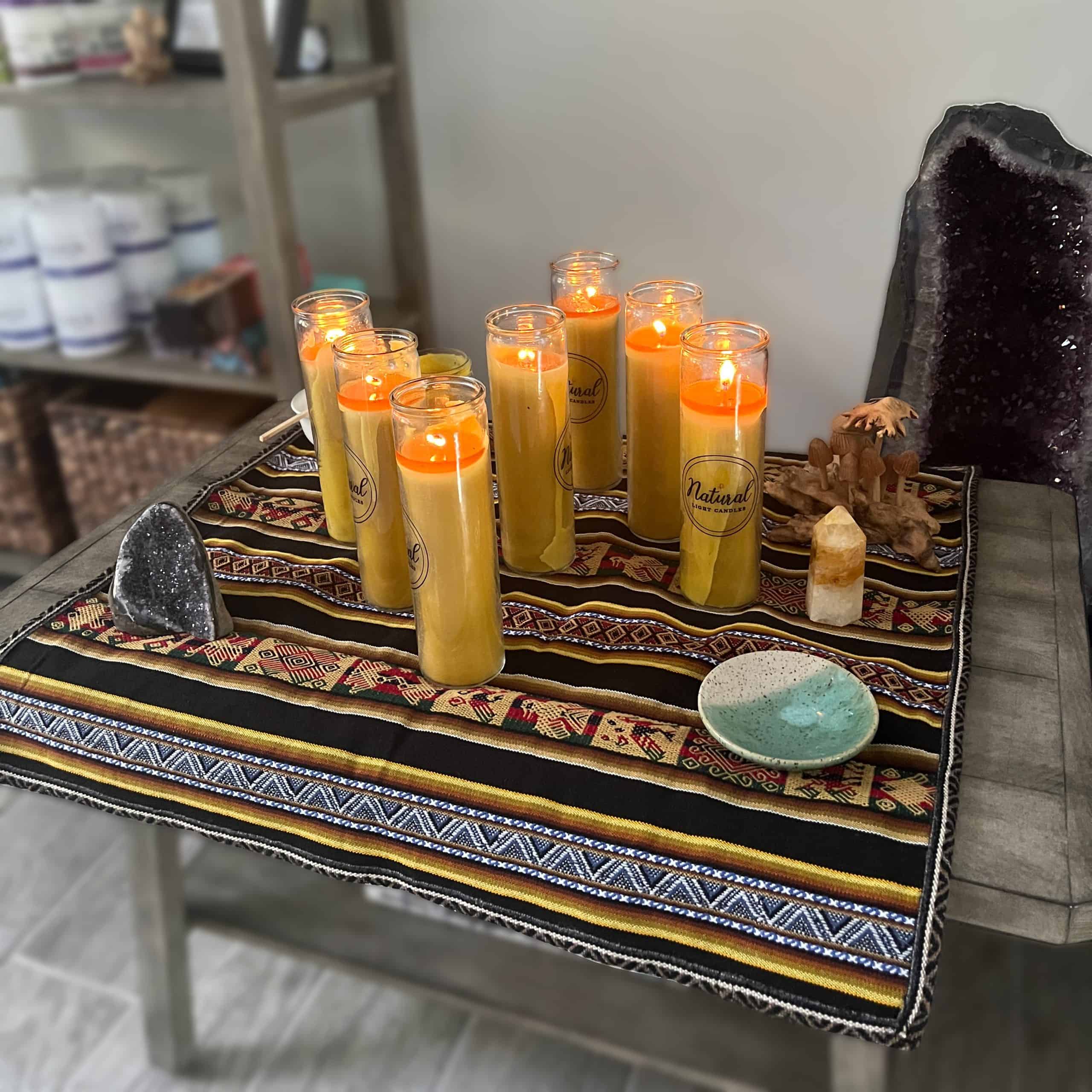 An altar with candles, stones, and instruments arranged for ceremony and reflection.