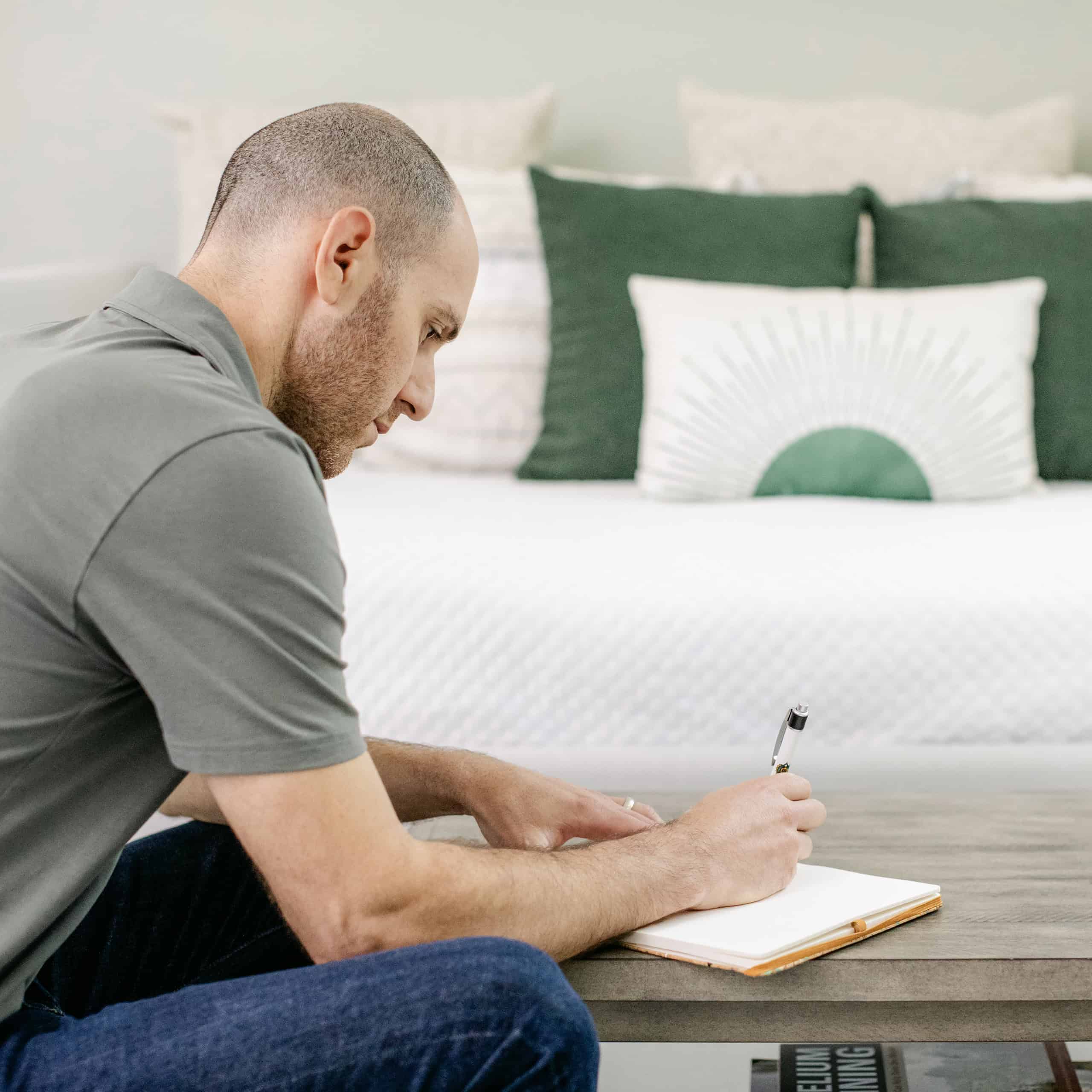 Yoni journaling in his studio, surrounded by natural light and stillness.